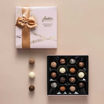 Butlers Chocolate Truffles packaging with a bow on a beige background