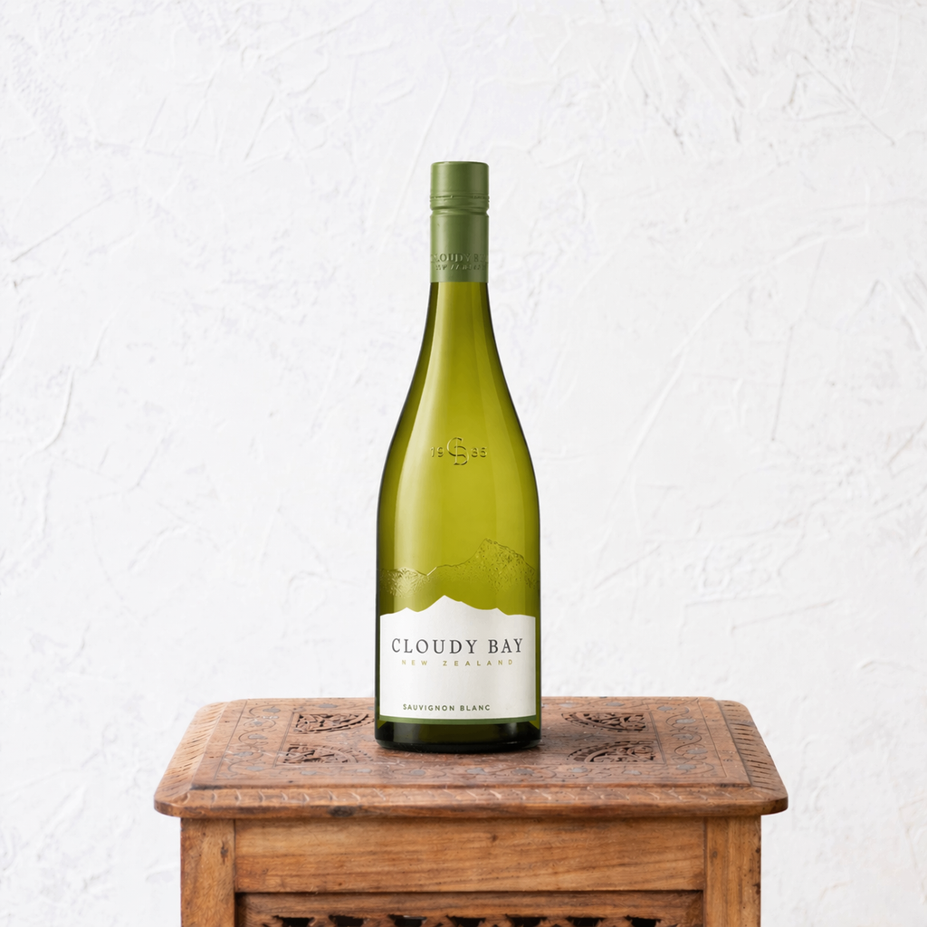 Cloudy Bay wine bottle on a wooden table with a white background