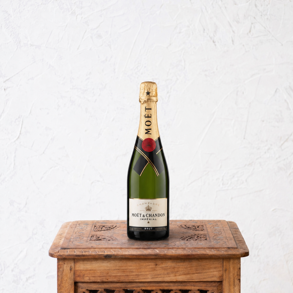 Bottle of Moët & Chandon champagne on a wooden table with a white textured background