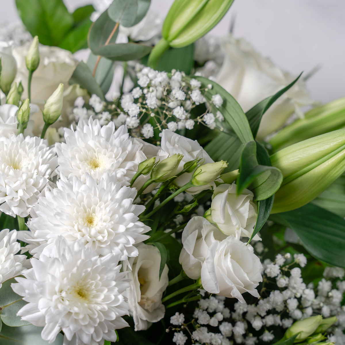 Ivory roses and white lilies close-up Tranquility bouquet The Flower Factory