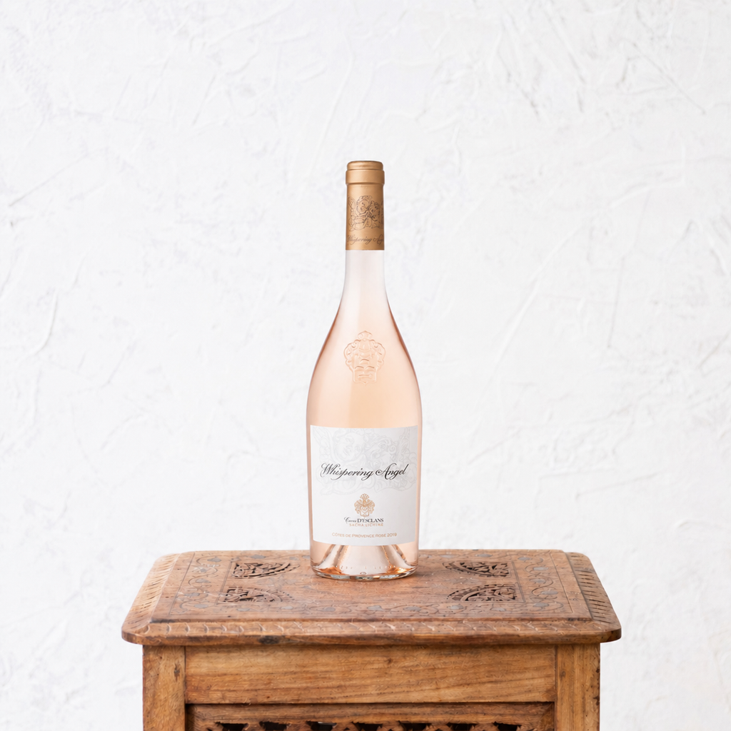 Rose wine bottle on a wooden table with a white background