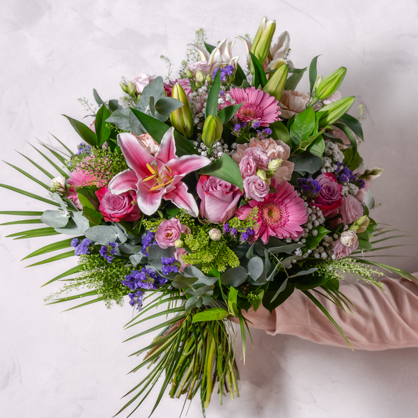 Full luxury fresh flower bouquet in soft pink and white tones, presented in elegant gift wrapping ready for delivery
