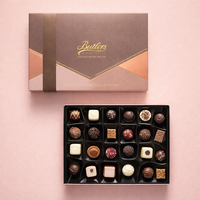 premium truffle chocolates on a plain pink background 