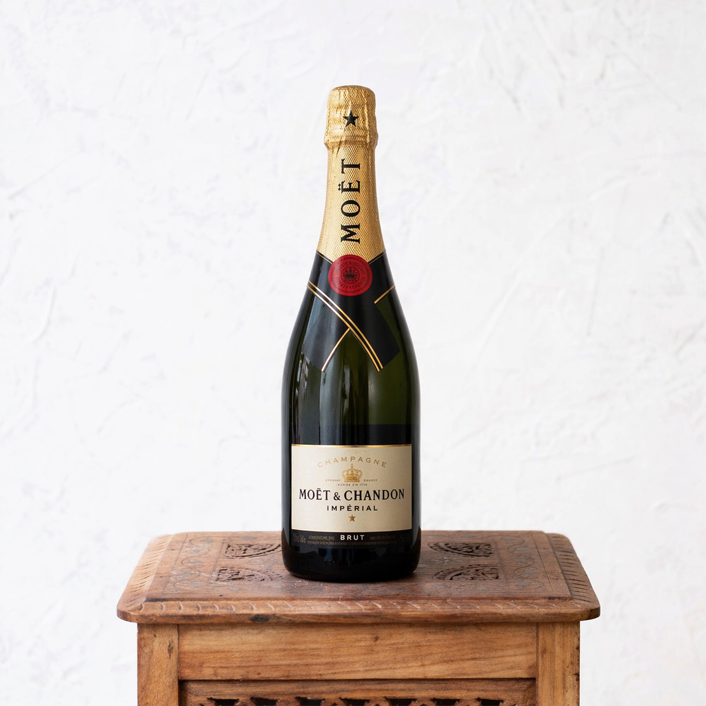 Moét & Chandon champagne bottle on a wooden stand with a white background