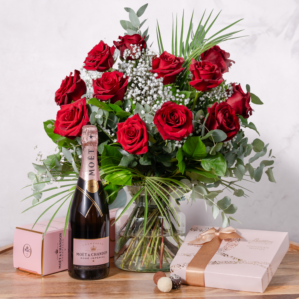 A romantic gift set featuring a bouquet of red roses, a bottle of Moét & Chandon Rose champagne, and a box of Butlers chocolates.