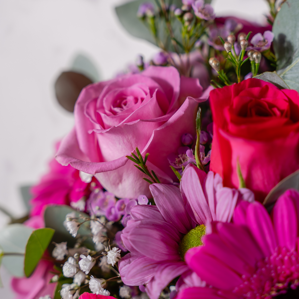 Close up of large-headed roses arranged inside the Signature Hatbox