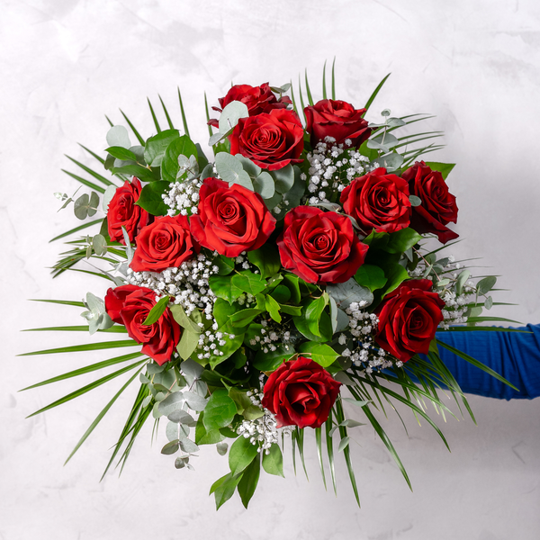 Close-up of twelve premium red rose blooms hand-tied bouquet The Flower Factory